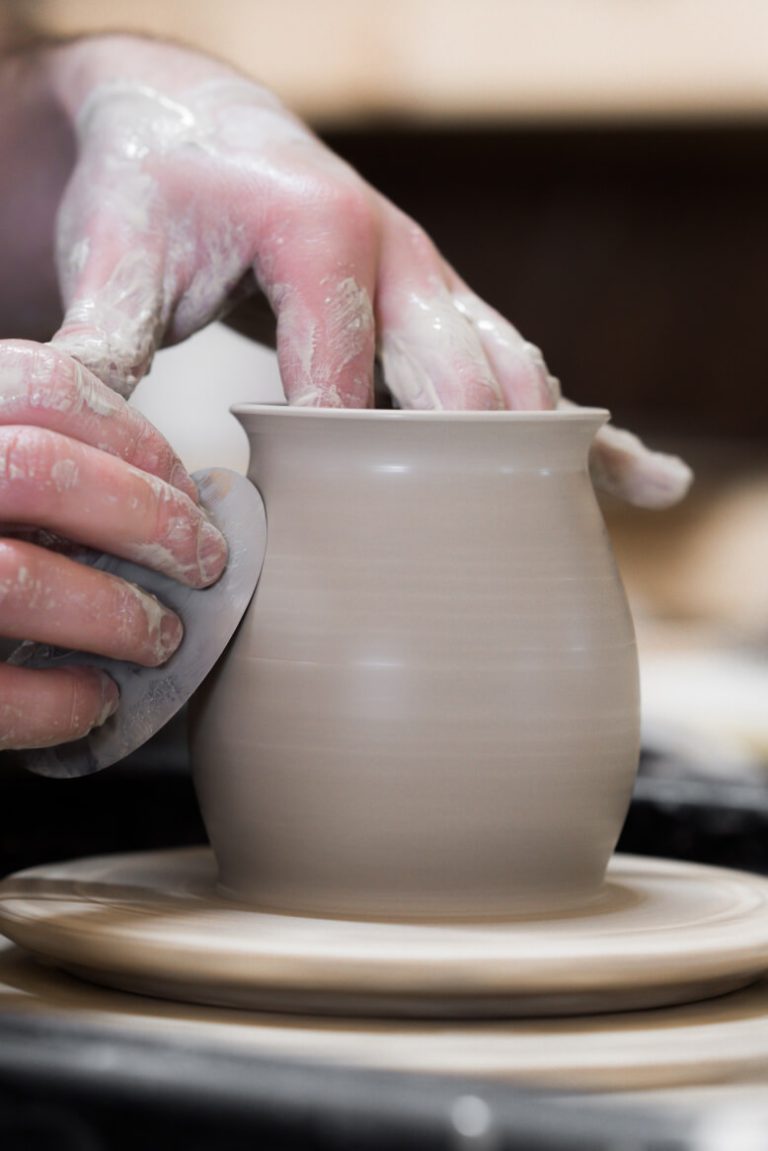 Image of a person throwing pottery on a wheel
